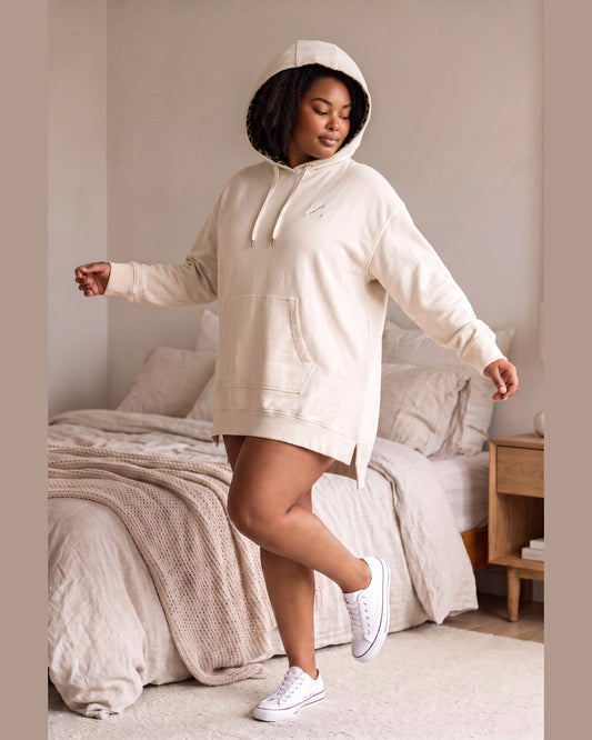 Women’s satin-lined hoodie dress with wide hood worn over natural hair