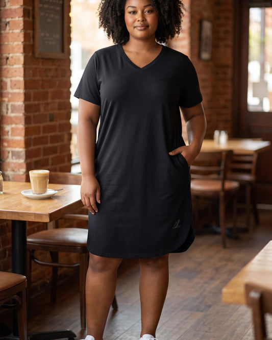 Lifestyle view of a woman wearing the Legacy black cotton-stretch dress for everyday casual styling.