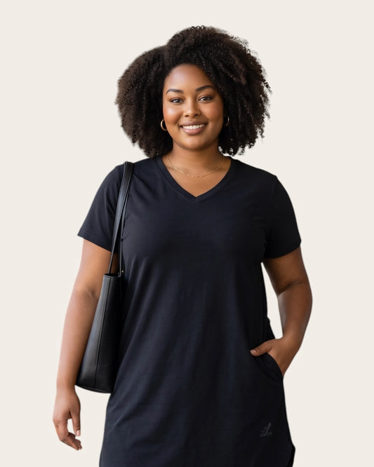 Woman in the Legacy black A-line pocket dress showing  hem shape.