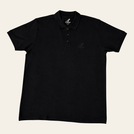 Close-up of tonal Legacy embroidery on a black cotton polo shirt.