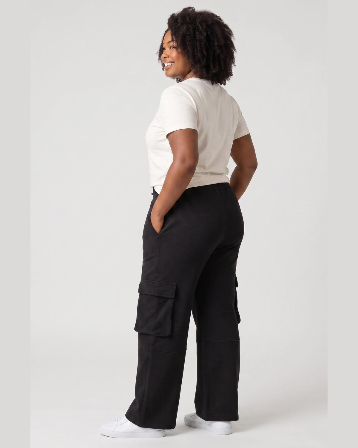 Back and side view of black Legacy cargo pants showing relaxed wide-leg fit and cargo pocket construction.