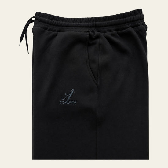 Black Legacy heavyweight organic cotton cargo pants front view with wide legs, drawcord waist and two cargo pockets.