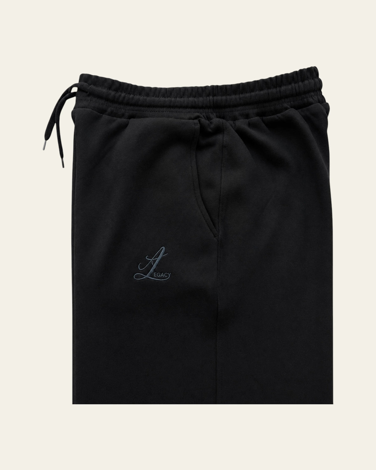 Black Legacy heavyweight organic cotton cargo pants front view with wide legs, drawcord waist and two cargo pockets.