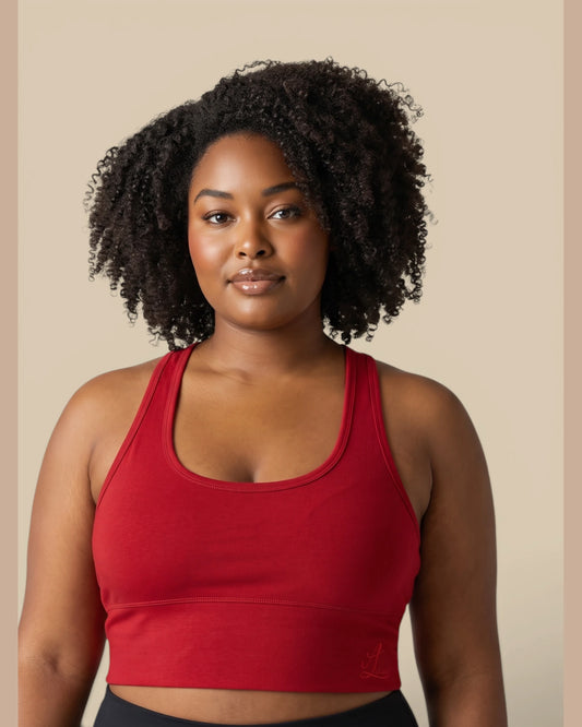 Close-up portrait of a model wearing the Legacy red cotton longline racerback sports bra.